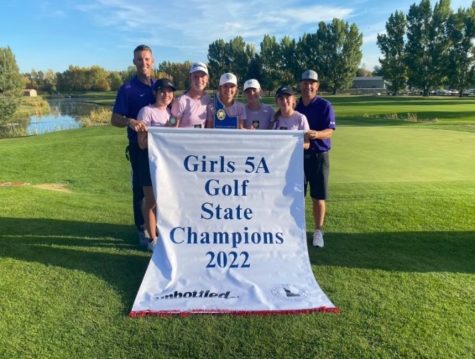 The Girls Golf Team poses for a picture holding their banner after their 3rd win in a row at State. 