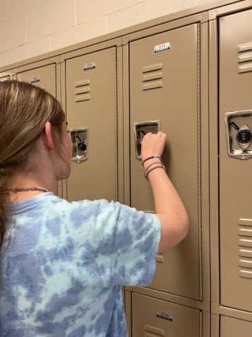 A rocky student opening a locker