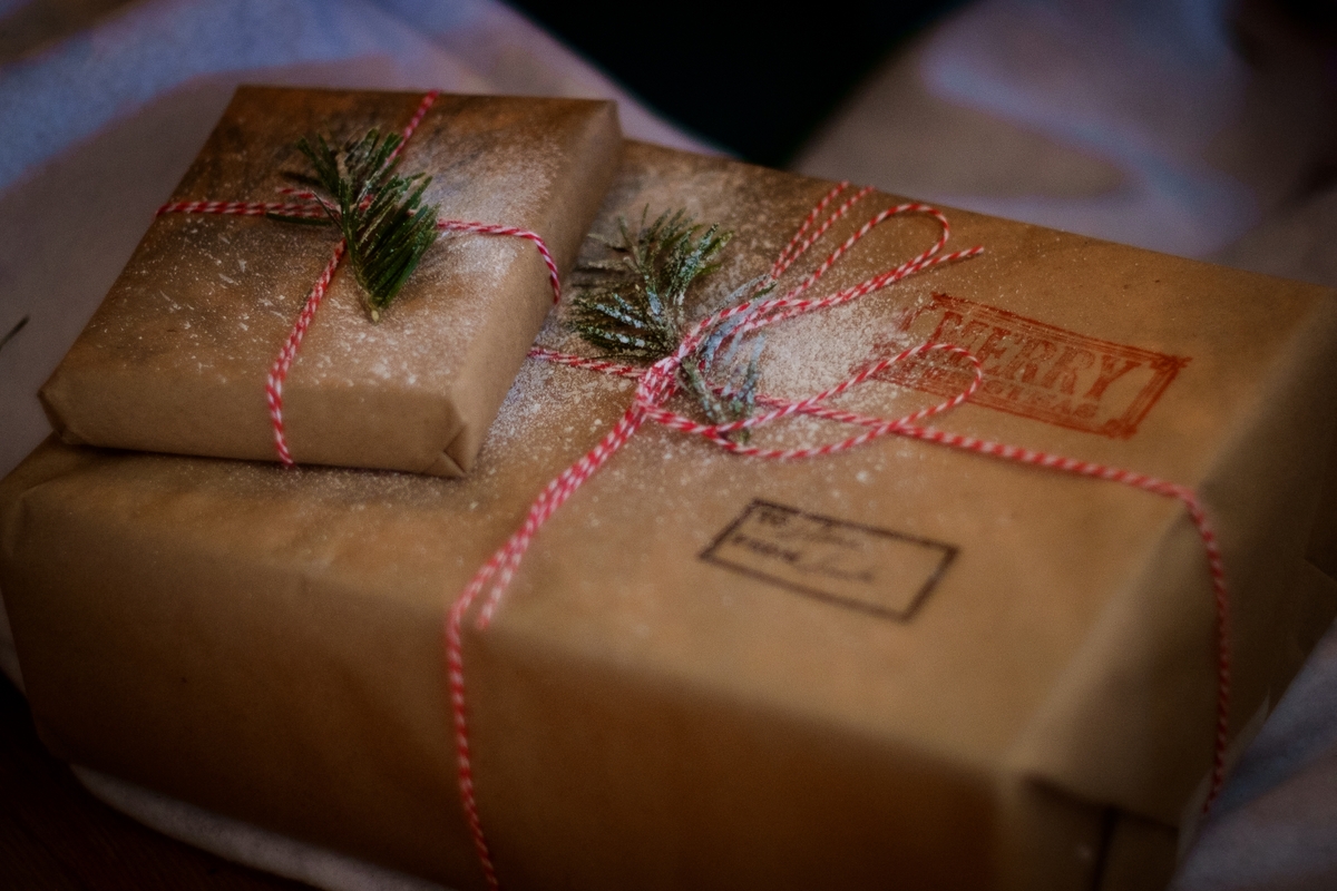Christmas presents wrapped in brown wrapping paper, resemble the gifts that will be given at the Wishmas assembly. Original public domain image from Wikimedia Commons. 