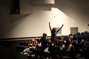 The auditorium erupts into cheers