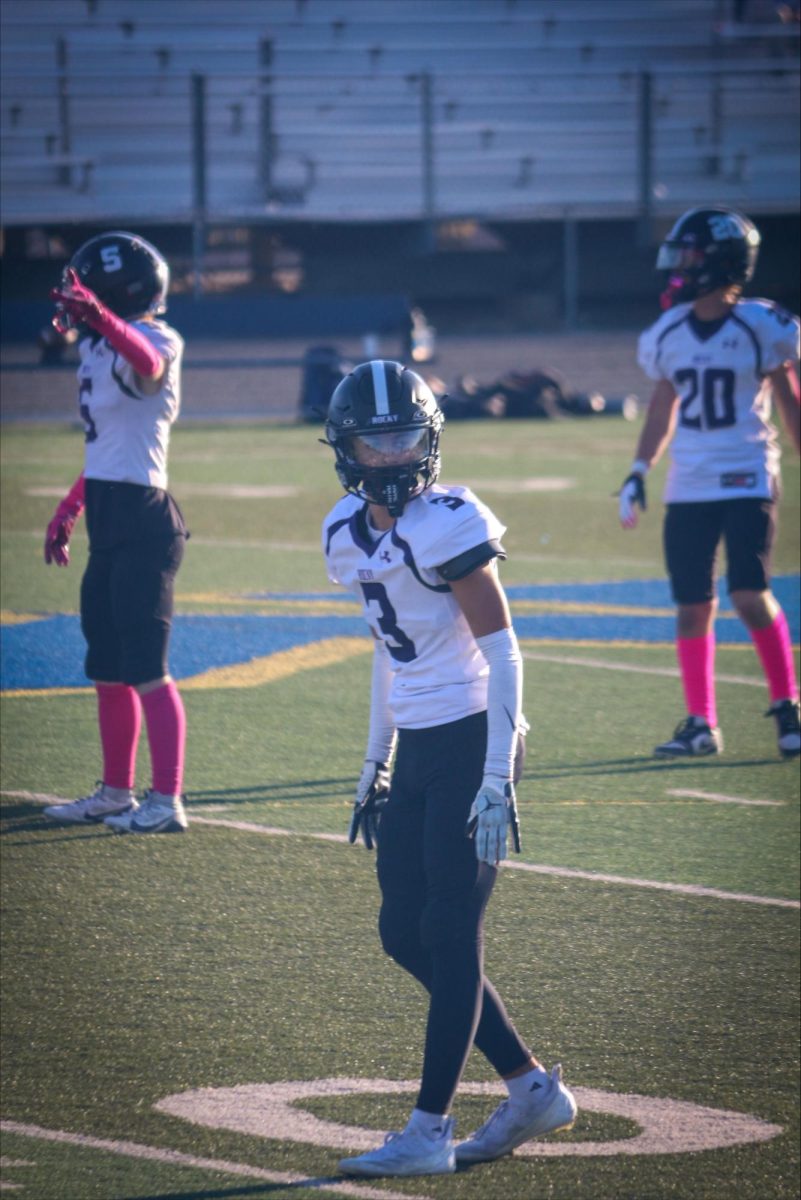 
Ethan Schramm locks in before the snap, ready to shut it down on defense – his focus fuels the game. 