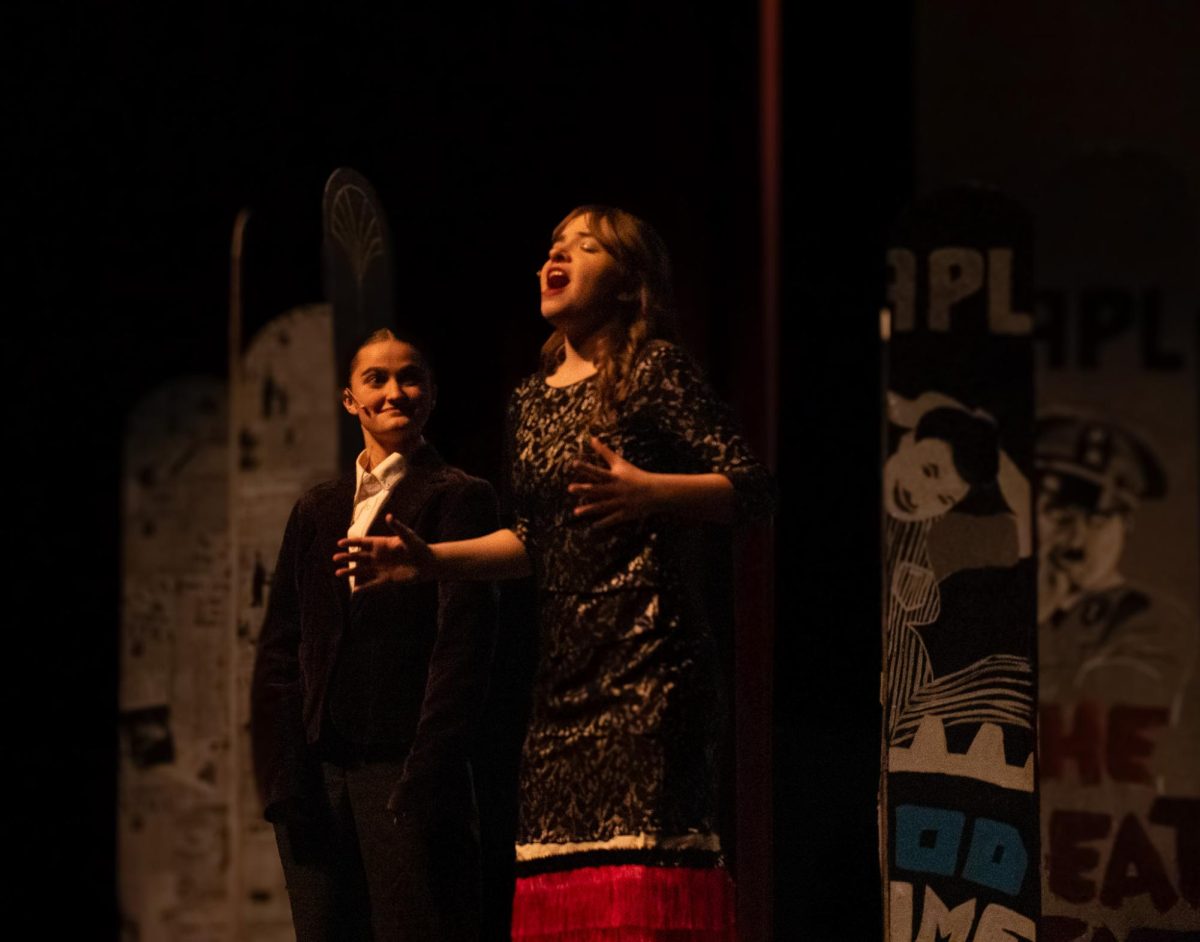 Young Charlie Chaplin (Olivia Truax) watching Hannah Chaplin (Katrina Kohler) mid song. The duo graced the audience with their pitch-perfect voices in the production of Charlie Chaplin the Musical.