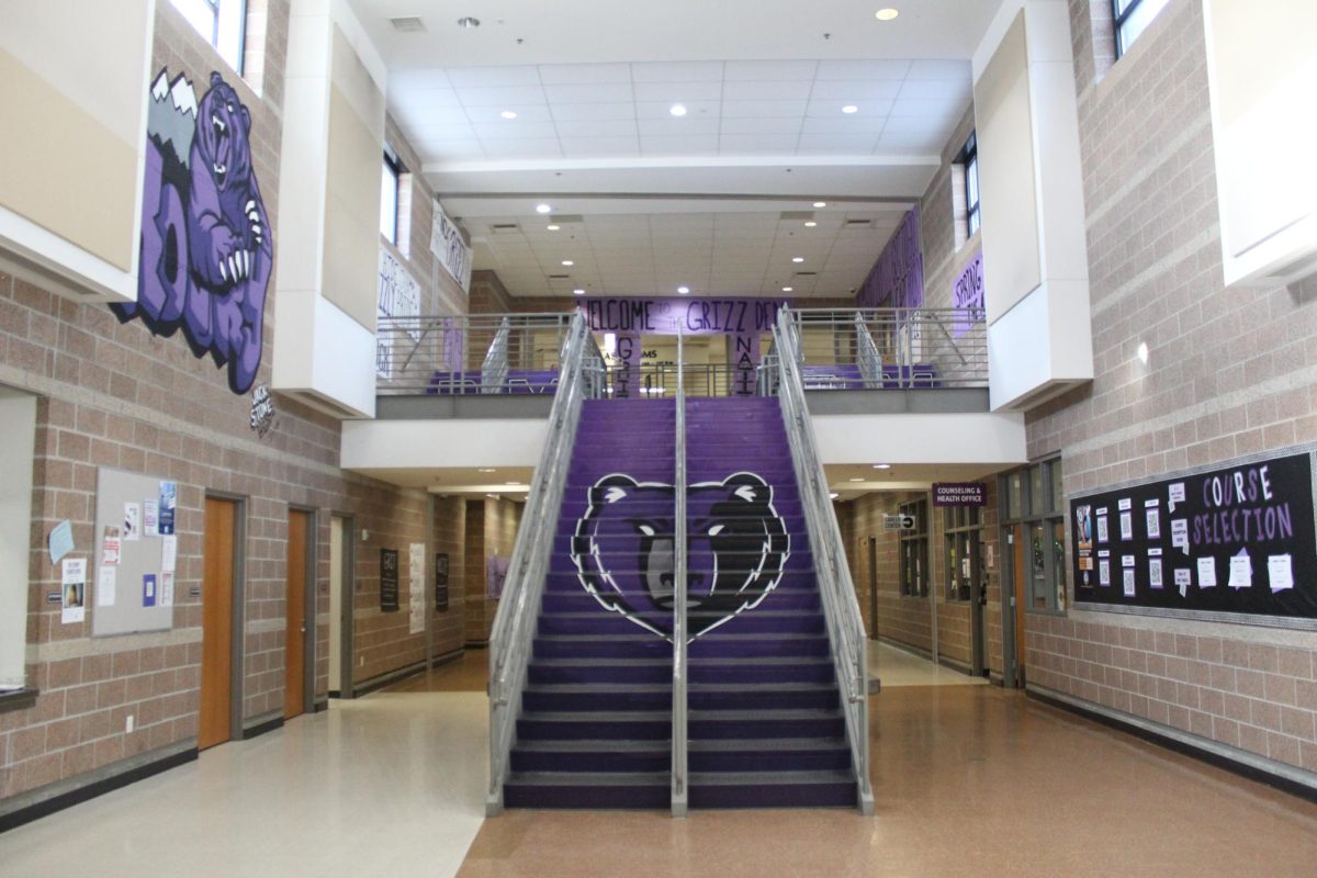 A photo of a flight of stairs depicting a purple bear