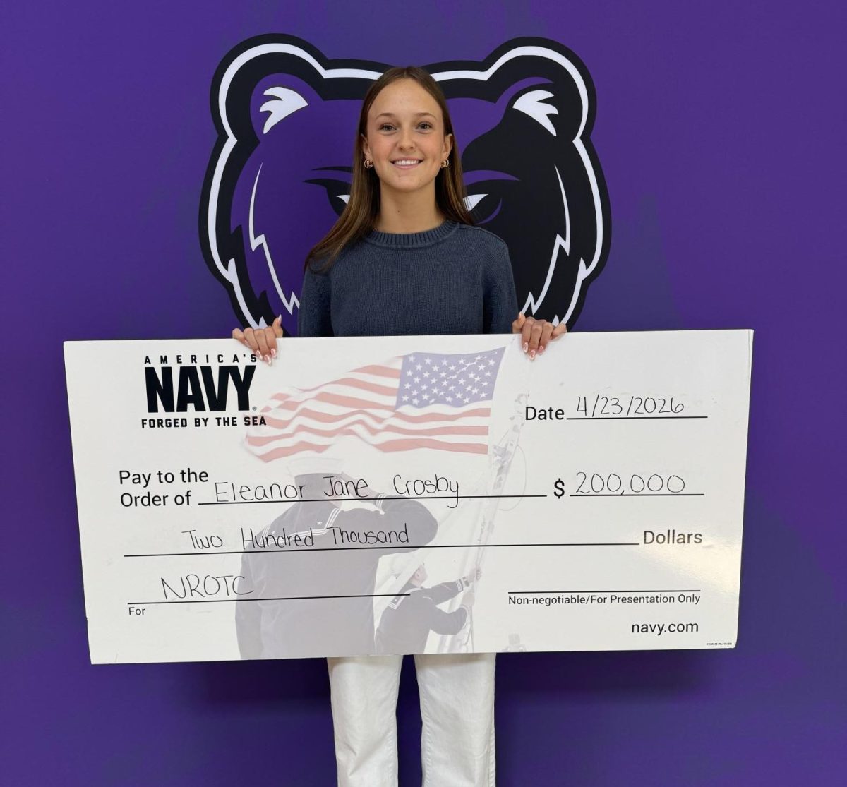 Smiling, Eleanor Crosby receives her NROTC Scholarship.